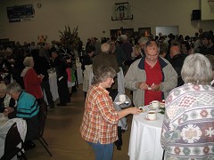 Concert goers enjoying the recpetion and dessert buffet.