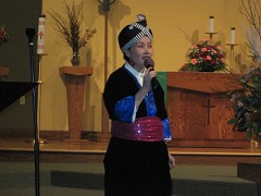 Donned in traditional attire, acclaimed Laotian singer, sang a beautiful song to welcome concert goers. Der Thao lives in Minneapolis, wore traditional attire sang her welcome wearing traditional attire.