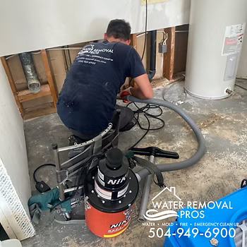 Water Removal Pros technician mitigating water damage in a utility and laundry room