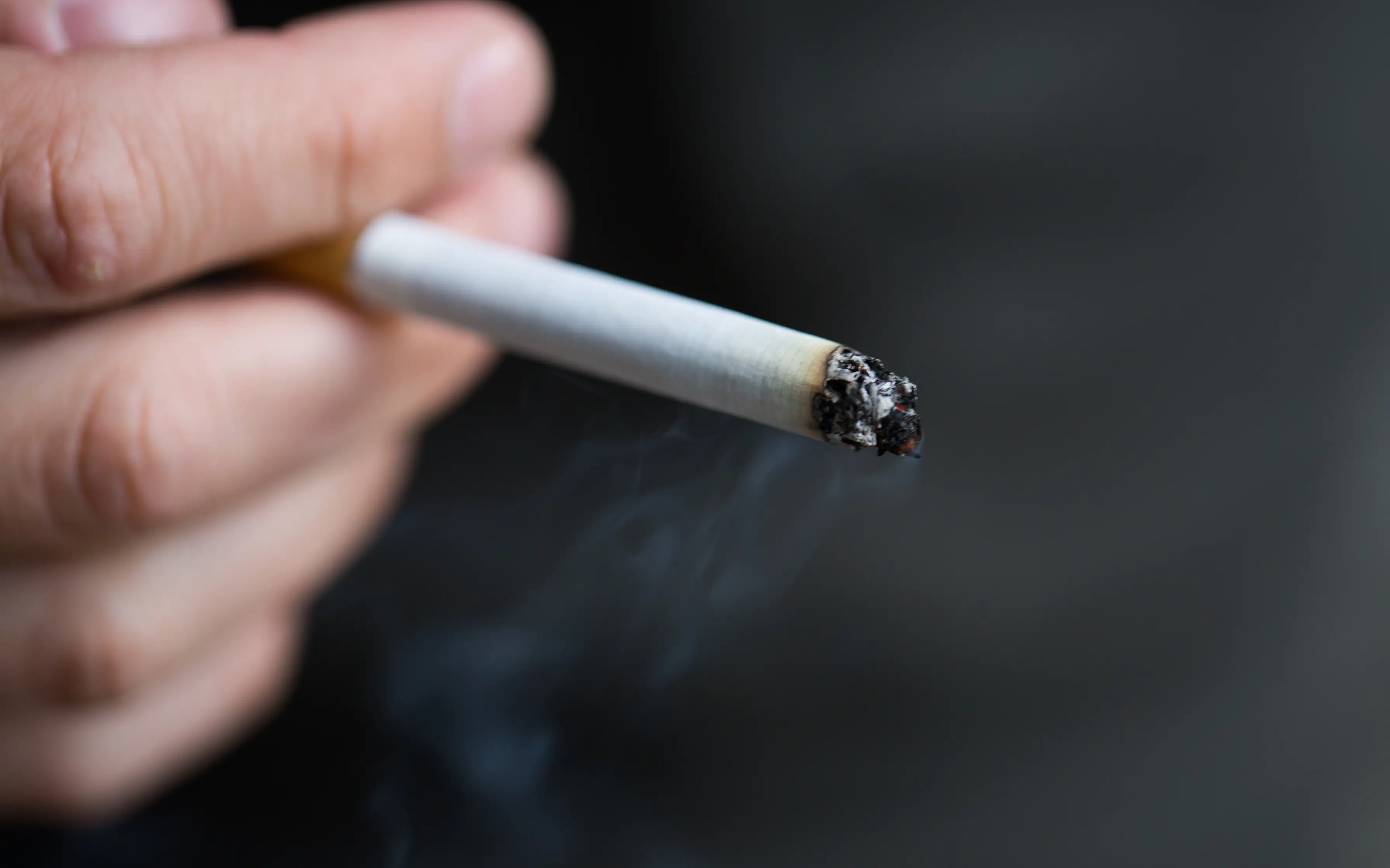 Lit cigarette with smoke eminating Cigarette smoke removal Colorado Springs, CO