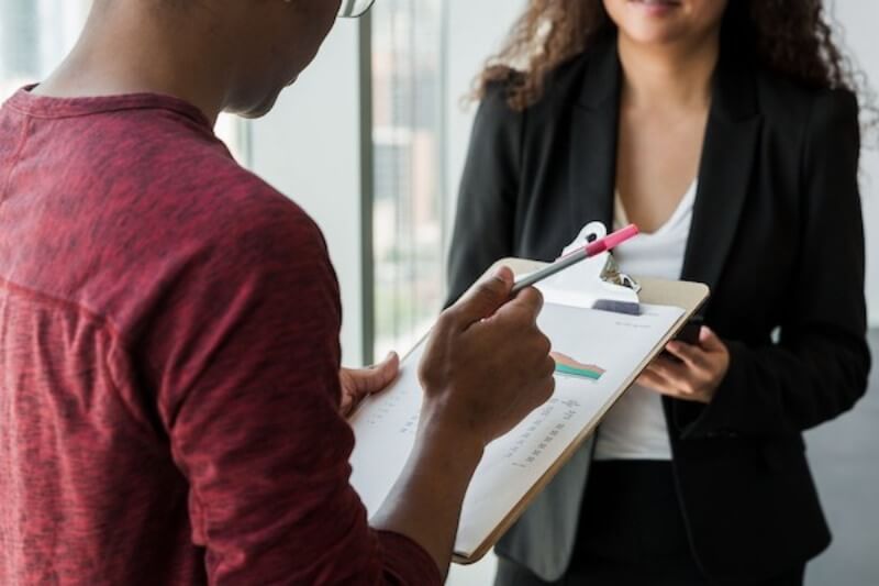 An image of two people transacting insurance claims