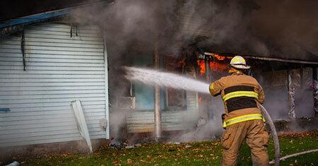 Fireman putting out house fire