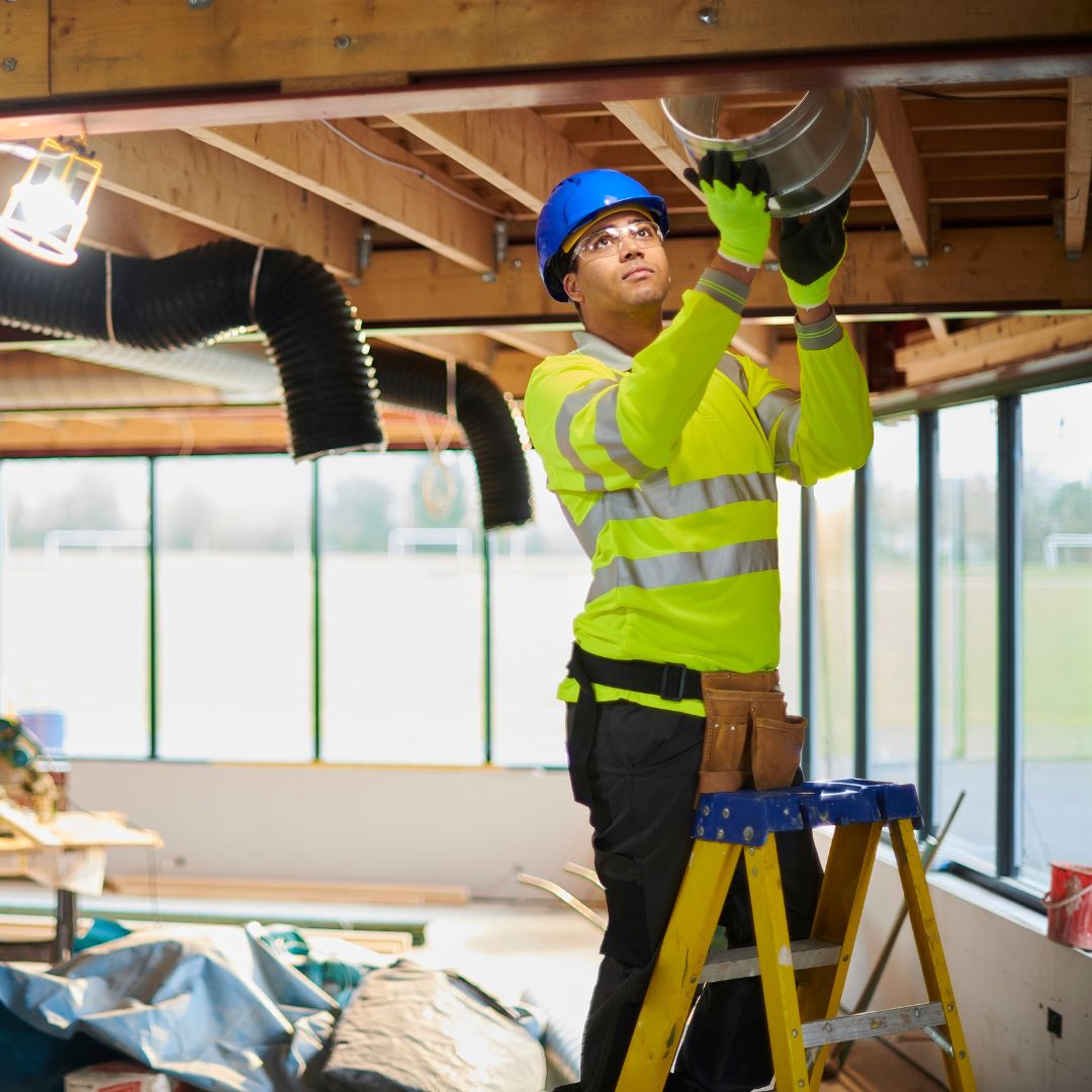 A contractor installing ventilation into a roof