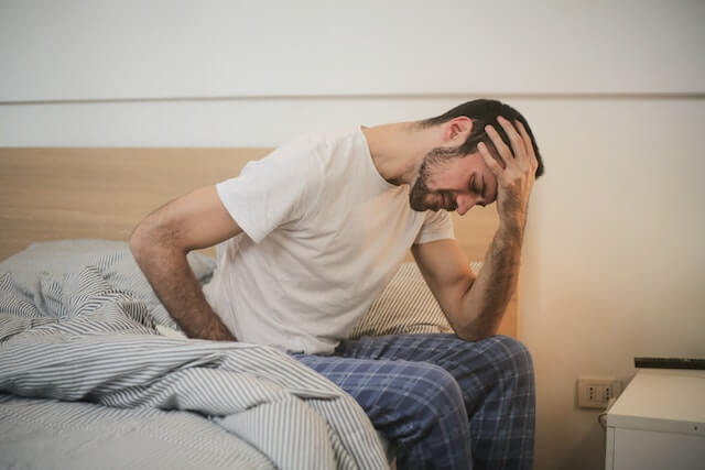 A man suffering from a terrible headache. A man suffering from a terrible headache.