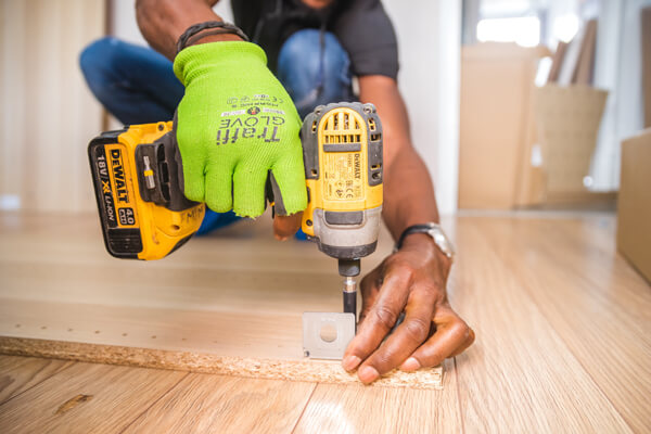 Refresh your home and boost its value with these easy upgrades. A close-up of a person working with a drill.
